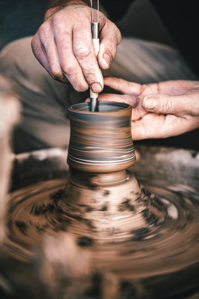 Hands of master in process of work in pottery.