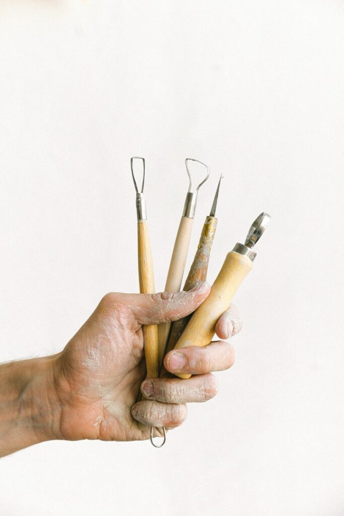 Hand Holding Pottery Tools